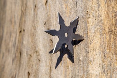 Shuriken (fırlatma yıldızı), geleneksel Japon Ninja soğuk silahı ahşap arka planda sıkışmış