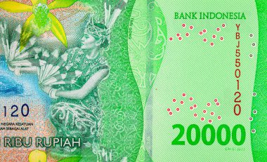 20.000 Rupiah Endonezya 'da Derawan Gölü kıyısında Tari Gong dansı yapan bir kadın resmi. Endonezya 'nın yeni parası.