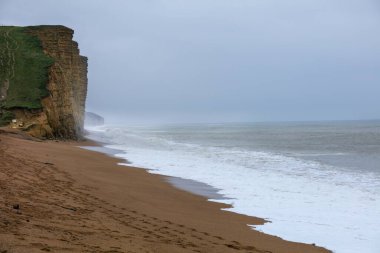 Batı Bay Dorset İngiltere 'deki kayalıklarda fırtınalı bir günde sabah ışığı.