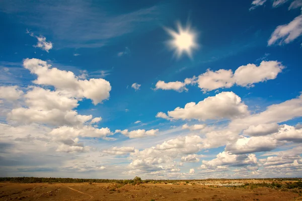 Country landscape in the background of sky with clouds and sun — Stockfoto