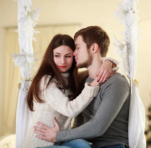 Couple in love embrace each other at home in festive decorations — Stock Photo, Image