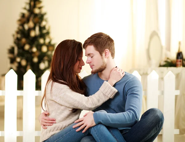 Couple in love embrace each other at home in festive decorations — Stock Photo, Image