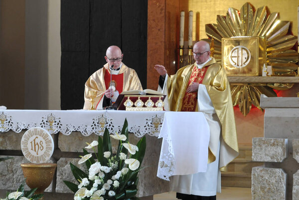 The Catholic Church, a solemn mass, the priest prays over the host, the symbol of the body of Christ. St. Paul the Apostle in Wieliczka near Krakow, June 11, 2021 ... 
