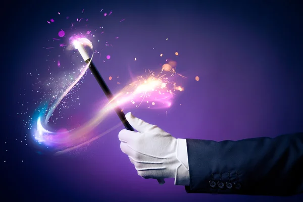 Magician hand with magic wand — Stock Photo, Image