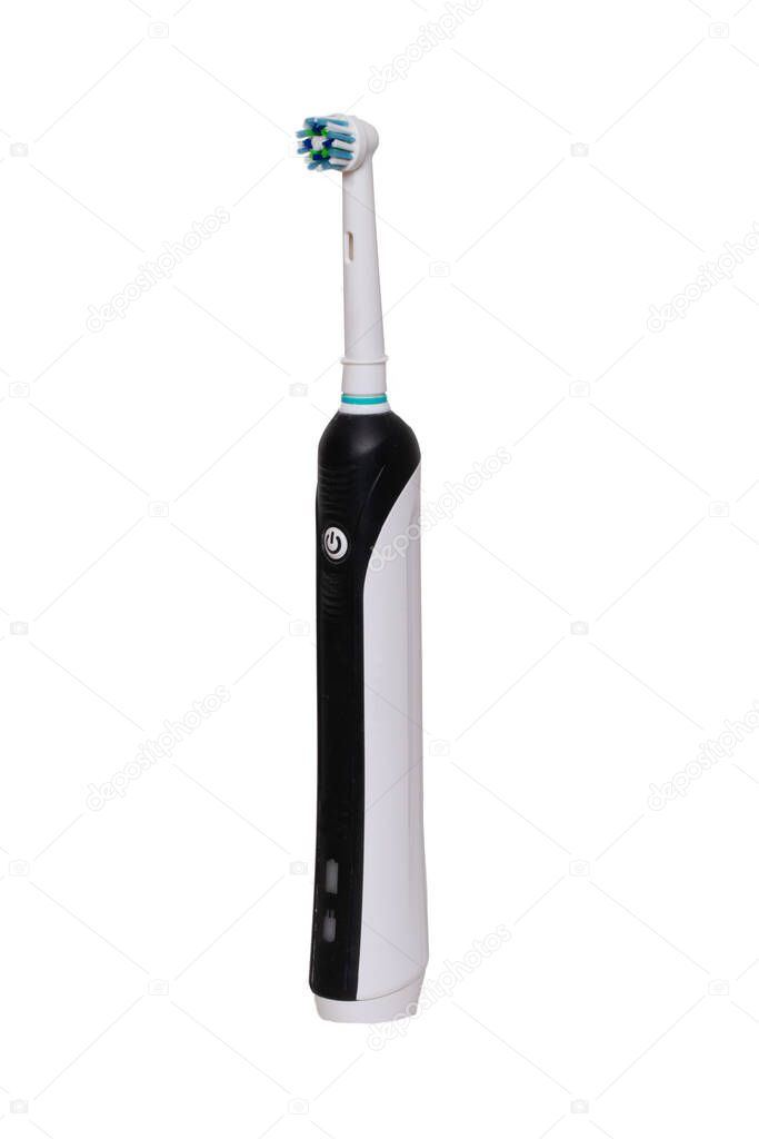 Electric toothbrush for teeth hygiene isolated on white background. Dental and healthcare concept. Macro photograph.