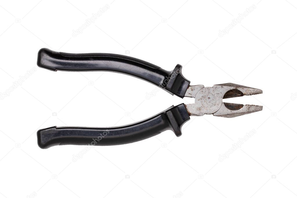 Pliers isolated. Close-up of an rusty well used metal combination pliers with black handle isolated on a white background. Macro photograph.