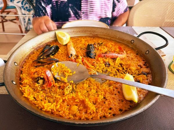 Seafood paella. Traditional Spanish rice dishes in restaurants. Rice, prawns and mussels. Healthy eating on the Mediterranean Sea. Spain, Costa Blanca, Alicante.