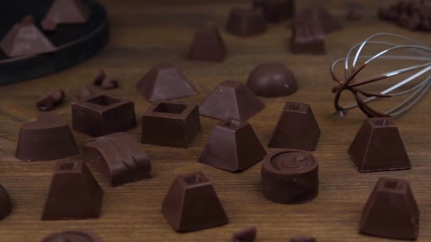 Assortment of handmade chocolate candy on wooden background. — Stock Video