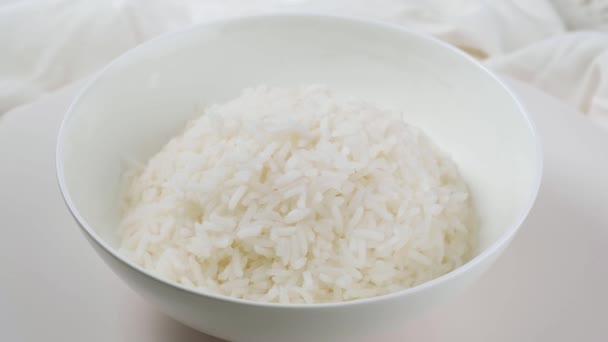 Cooked rice in white plate on white background. — Stock Video