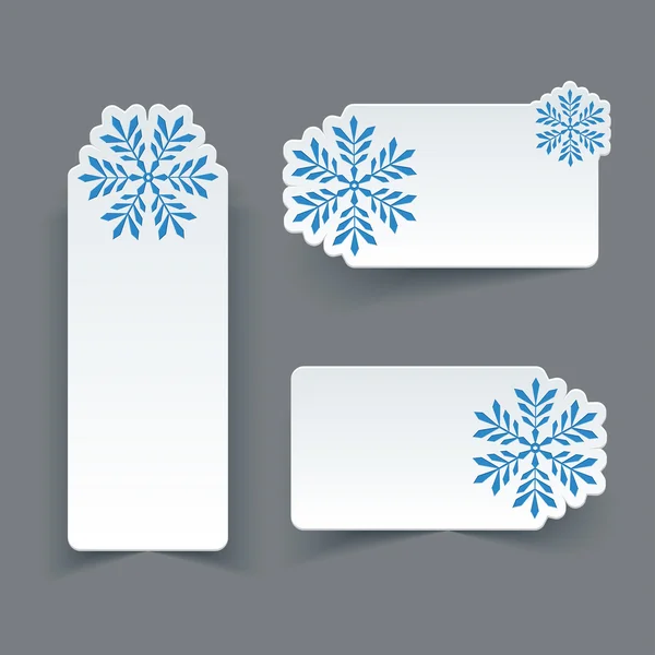 Conjunto vectorial de etiquetas retro de papel blanco en blanco con copos de nieve . — Vector de stock