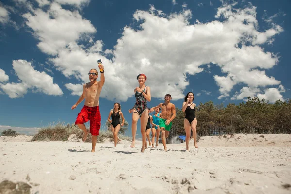 Grupa Przyjaciół Składająca Się Mężczyzn Kobiet Biegających Plaży Morzu — Zdjęcie stockowe