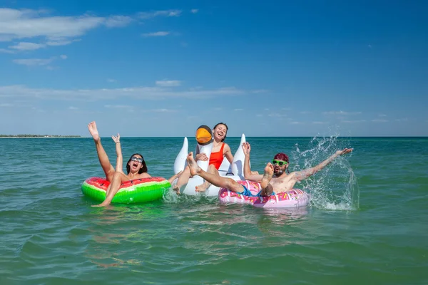 Two Young Women Man Rubber Rings Sea Summer Royalty Free Stock Photos