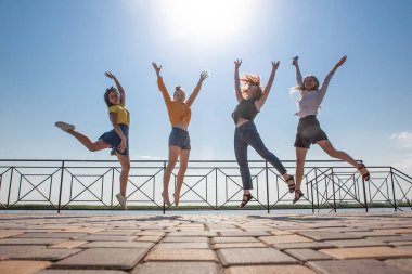 Yazın atlarken dört kadının fotoğrafı çekiliyor.