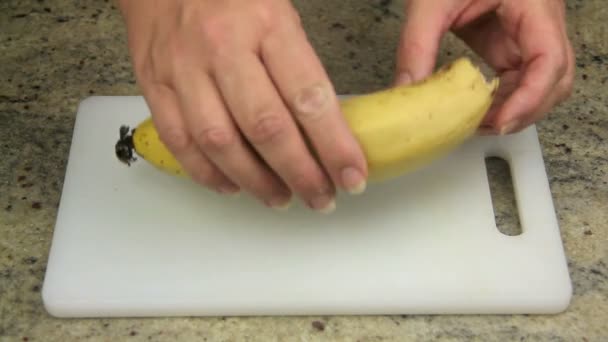 Peeling a fresh banana for cooking — Stock Video