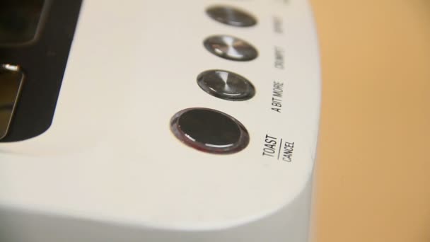 Pressing a toaster button and English crumpet drops into a toaster to be toasted. — Stock video