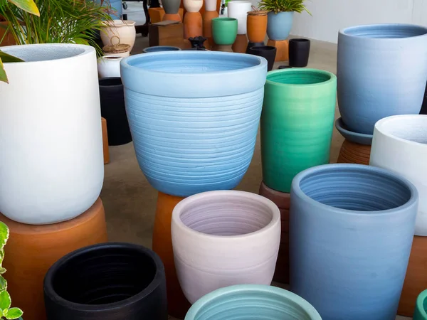 Various colorful ceramic plant pots in the shop. Empty geometric ceramic planter background.