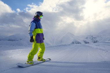 dağlarda gemide duran snowboarder 