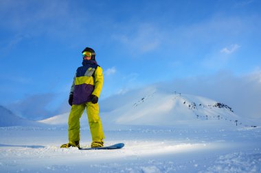 dağlarda gemide duran snowboarder 