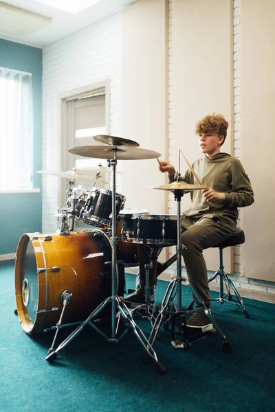 Il ragazzo al drum set suona energico. — Foto Stock