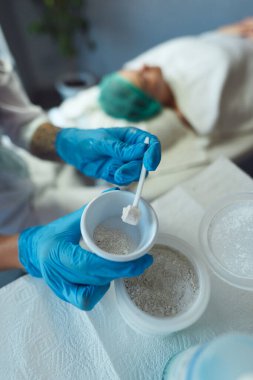 Yüz için soyulan enzimin hazırlanma süreci. Bir kupa bir güzellik uzmanının ellerinde.