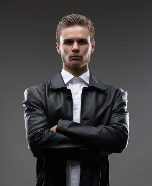Serious man in a leather coat — Stock Photo, Image