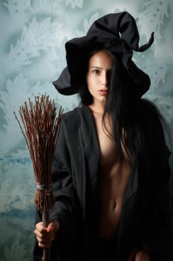 sexy girl in witch costume with a broom clipart