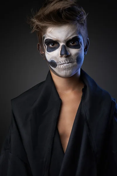Teen with make-up of skull in black cloak unhappy — Stock Photo, Image