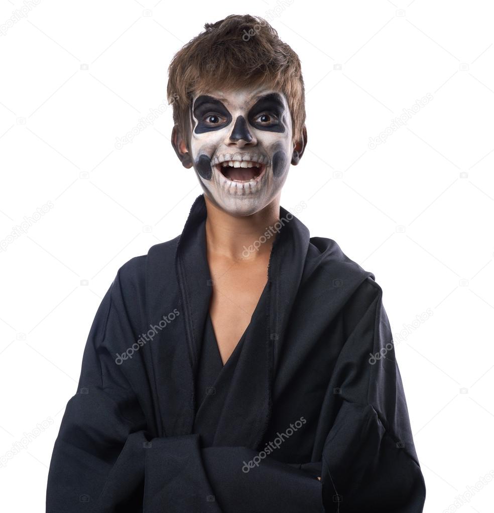 Teen with make-up of skull in black cloak laughs