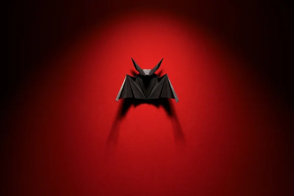 Origami bat on a red background — Stock Photo, Image