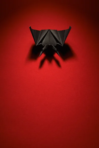 Origami bat on a red background — Stock Photo, Image