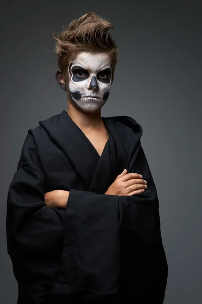 Teen with make-up of the skull in black cape — Stock Photo, Image