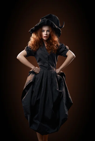 Beautiful red-haired girl in the witch costume — Stock Photo, Image