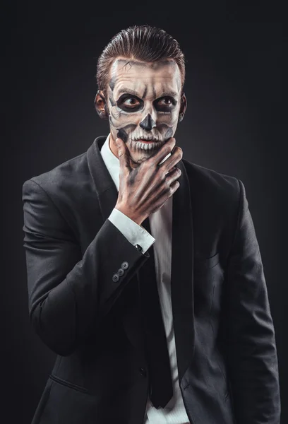 Pensive businessman with makeup skeleton — Stock Photo, Image