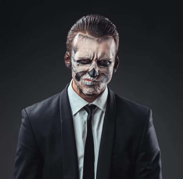 Incredulous businessman with makeup skeleton — Stock Photo, Image