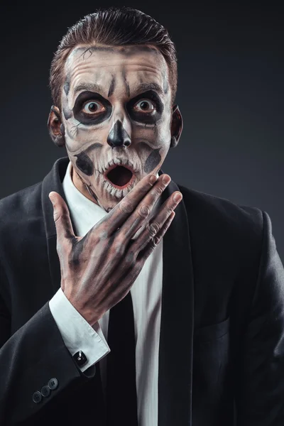Surprised businessman with a makeup  skeleton — Stock Photo, Image