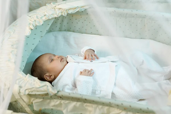 Liten baby som sover i krybben – stockfoto