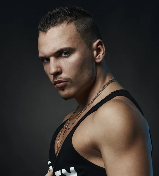 Portrait of  strong man on a black background — Stock Photo, Image