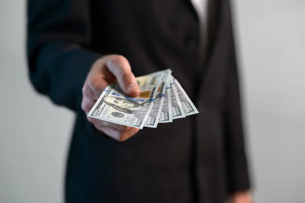 Man takes  handful of money — Stock Photo, Image