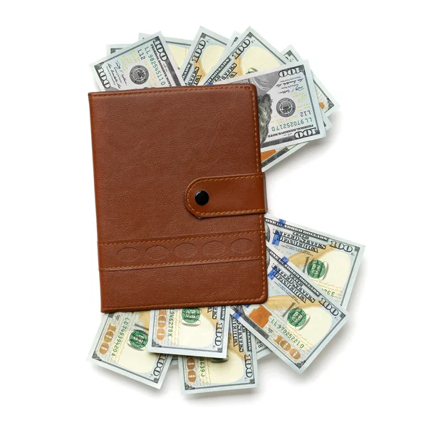 Notebook stuffed with  dollar bills — Stock Photo, Image