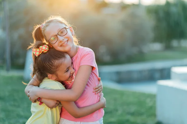 Twee zussen zijn knuffelen in het park — Stockfoto