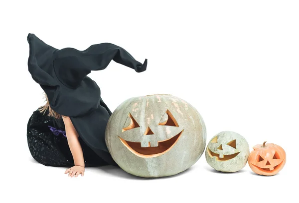 Witch sits in line with pumpkins — Stock Photo, Image