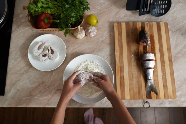 Girl roll slice of  fish in flour the kitchen — Stock Photo, Image