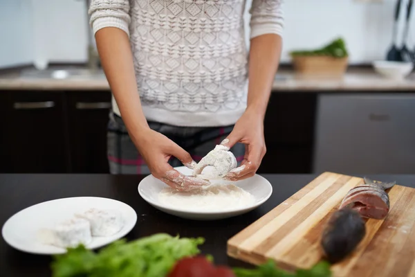 Girl roll slice of  fish in flour  kitchen — Stock Photo, Image