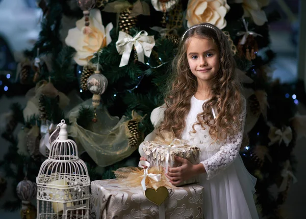 Beautiful girl in white dress enjoys  gifts — Stock Photo, Image