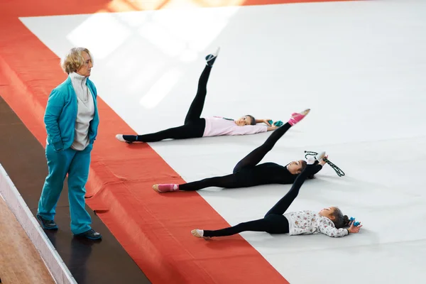 Trainer monitors compliance stretching exercises for  legs — Stock Photo, Image