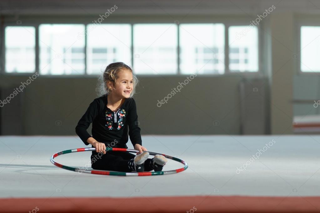 beautiful girl laughing with  hoop of rhythmic gymnastics.