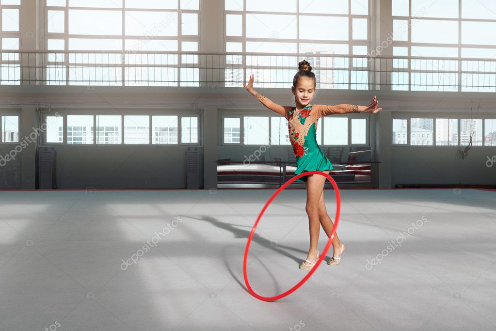 girl in dress dancing with hoop gym-hall