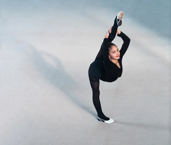 Beautiful girl in a black suit makes the balance — Stock Photo, Image