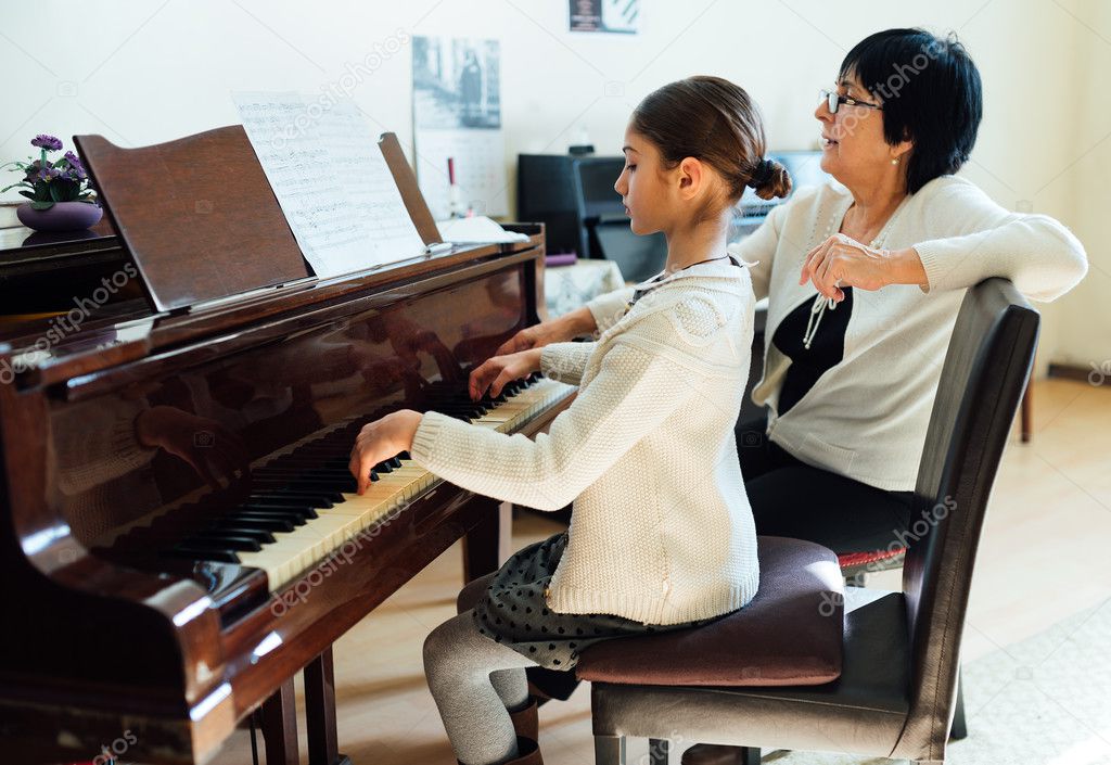 piano lessons at  music school, teacher and student.