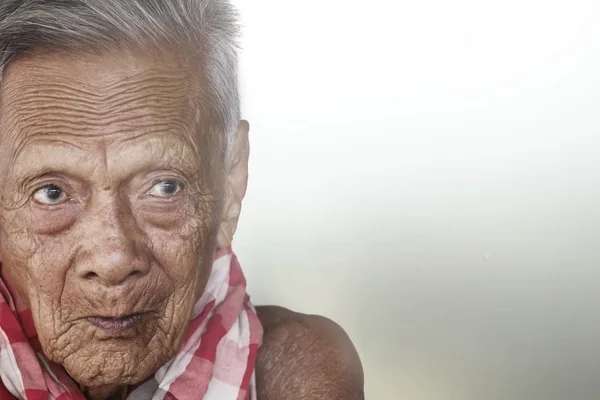 Old man face close seup eyes looks at camera — стоковое фото